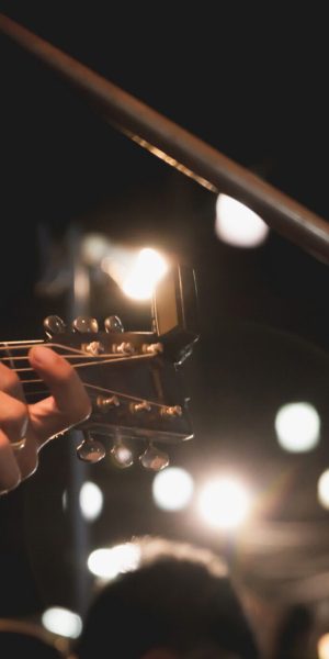 Guitarist on stage. Guitarist playing guitar, soft and blur concept.